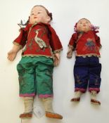 Two early 20th century Chinese dolls with papier mache heads and contempory costume, tallest 40cm