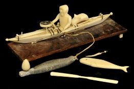 An Inuit carving ivory of a Fisherman in a Boat with seal, 15cm long (Please visit our website for