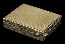 A rectangular white metal compact with engined and engraved decoration, possibly silver indistinct