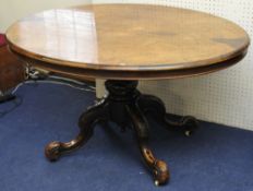 Victorian figured walnut oval breakfast table on quatrefoil base with tip-up top, 134cm long