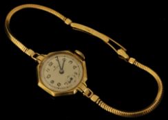 A ladies traditional Rolex wrist watch in 9ct gold with sub second dial