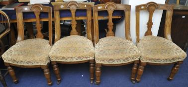 Set of four Victorian mahogany framed dining chairs with overstuffed seats and carved turned legs