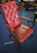 A mahogany framed rocking chair with red leather upholstery button back upholstery