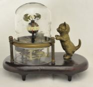 A patinated metal cat clock automaton, having an exposed movement and rising on an oval base
