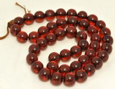 Row of red amber beads approx 99g