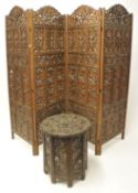 Ornately carved and pierced folding four leaf screen and similar folding carved table