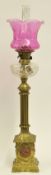 Tall brass column oil lamp with glass reservoir and pink glass shade approx 95cm