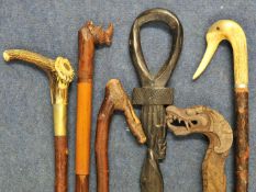 A collection of 11 various walking sticks including carved dragon design and antler mounted, (