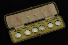 A set six 18ct gold and mother of pearl dress studs in fitted box