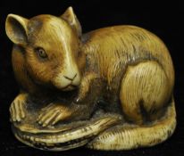 A carved stained ivory? Netsuke mouse, 3cm long