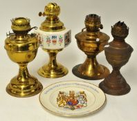 Four various brass and other oil lamp bases, 34cm