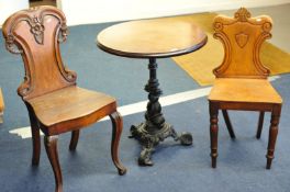 An occasional table with decorative east iron base together with two Victorian hall chairs