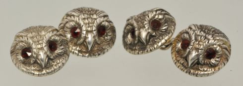 Pair of silver cufflinks in the form of owls heads set with red eyes