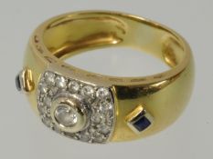 A sapphire and diamond ring set in wide gold band stamped .750, size L.