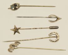 Five silver stick pins including horseshoe and clover