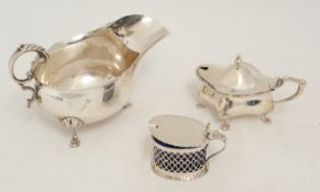 Silver sauceboat, silver and pierced mustard pot and another silver mustard pot with blue glass