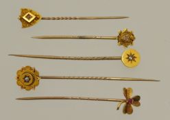 Five 15ct gold stick pins including four set with diamonds