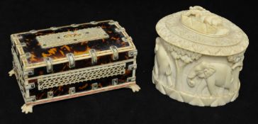 A carved ivory box and cover, decorated with elephants 10cm high, and a tortioshell style and bone