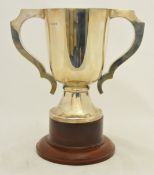 A George V silver twin handled trophy approximately 29.7 oz, 23cm and a turned wood socle