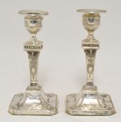 Pair of Victorian silver candlesticks of Adam design decorated with swags and urns, 17cm