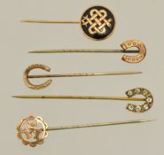 Five yellow metal stick pins including horseshoe etc