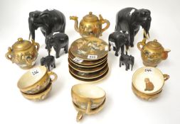 A Japanese earthenware tea service `faces` also some carved elephants