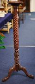 A mahogany Torchere with spiral column and tripod base, 135cm high