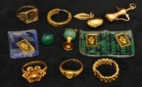 Various gold jewellery including four rings and a charm (two rings stamped 21K and 22K) also small