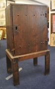 An antique oak cupboard with single door on a plain stand , 101cm high