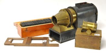 A magic lantern and case with gate slide, focusing lens in wood box together with a collection of