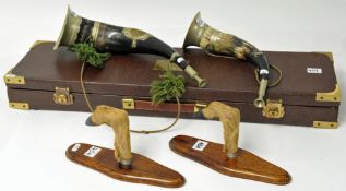 Taxidermy. A pair of gun rests `deer hooves`, a pair of hunting horns and brass bound gun case