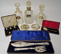 Three glass decanters, one with silver effect mount, two silver labels, various other items