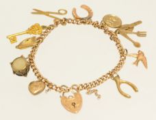 An 18ct gold chain having ten 9ct gold charms, approx 15g total