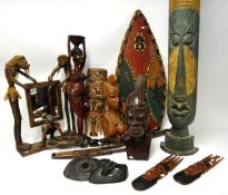 Collection of ten reproduction tribal figures and artifacts including shield and ornate carved