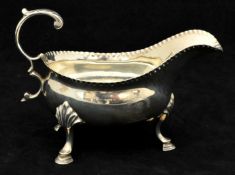 Victorian silver sauceboat with scroll handle, three legs and hoof feet, approx 5.20oz