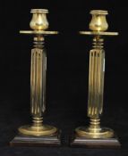 A pair of heavy brass candlesticks, with fluted square columns 22cm