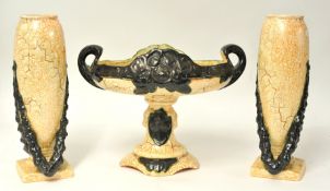 A three piece pottery garniture, Eichwald, the vase 32 cm high