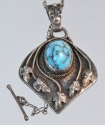 An Art Nouveau silver pendant set with blue veined cabochon stone, with fine chain, 30mm x 25mm