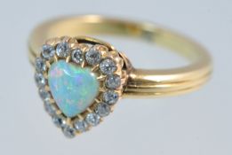 A fine opal and diamond ring of heart design, size N