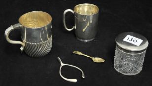 A silver stirrup, two silver mugs (one with wrythen twist body), silver top jar and spoon (4),