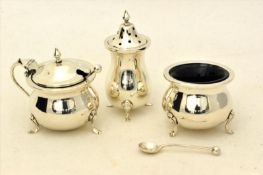 Plain silver complete condiment set, comprising salt, pepper and mustar cellars on three feet.