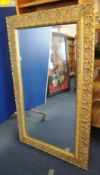A modern and bevelled plate wall mirror with ornate gilt frame, 87cm x 147cm.