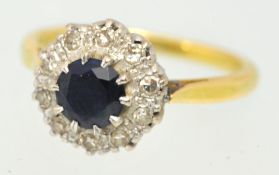 A sapphire and diamond cluster ring set in yellow gold size, J.