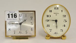 Two Swiza 8 day clocks in oval brass cases with alarm, 8cm.