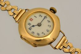 18ct gold Ladies wrist watch, the circular dial with red twelve with rolled gold bracelet.