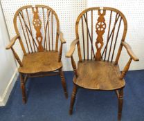 Pair of Windsor Wheelback elbow chairs with elm seats.