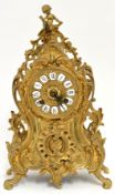 An ornate brass cased clock with `ting tang` style movement, 41cm high.