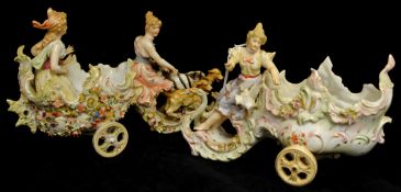Pair of German porcelain groups depicting figures in a chariot pulled by winged dogs (some