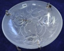 An iridescent glass hanging light pendant decorated with roses embossed with registration number,