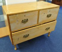 Stripped pine three drawer chest with brass drop handles, 96cm wide.